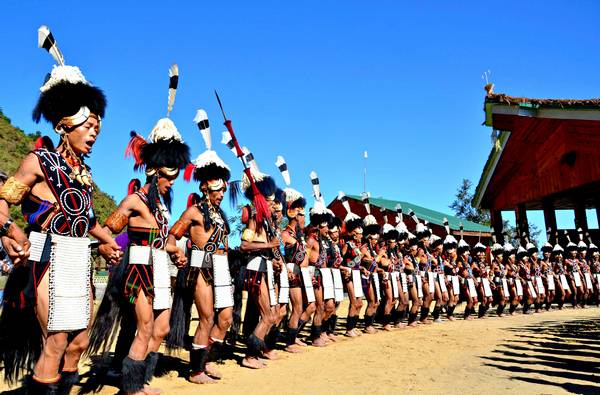 Kohima, India. 2nd December 2012 -- Naga tribesmen dressed in traditional costumes perform on the second day of the state annual Hornbill festival at Kisama. -- The week long Hornbill Festival of Nagaland, which celebrates the cultural heritage of the sixteen Naga tribes continues in Kohima India.