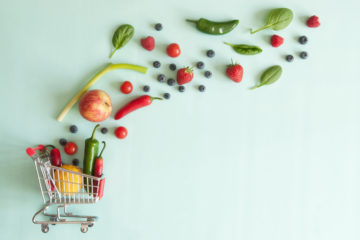 Shopping cart full of organic vegetables and fruits