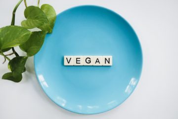 The word 'VEGAN' spelled out on a blue plate -Pure & Eco India