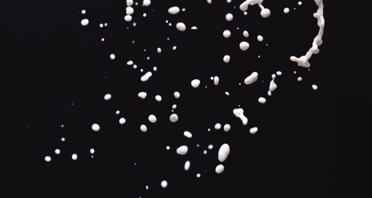 Milk droplets on black background-Pure & Eco India